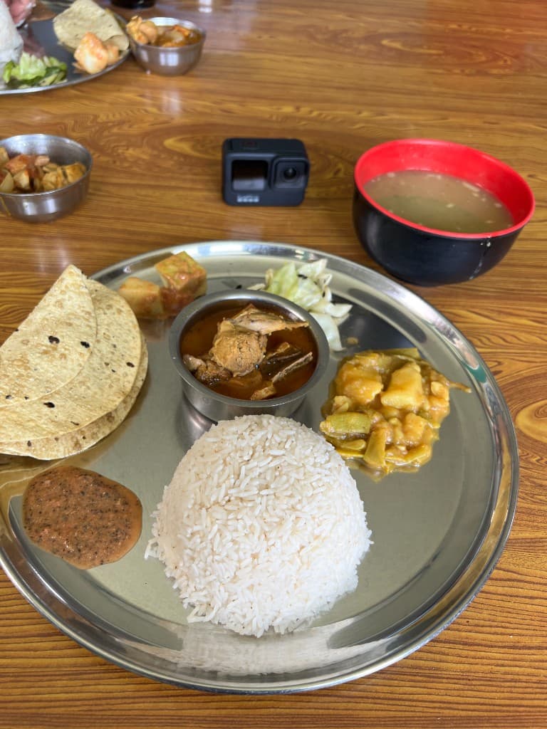 Dal bhat thali with rice, curry, roti and lentil soup at an ABC trek teahouse
