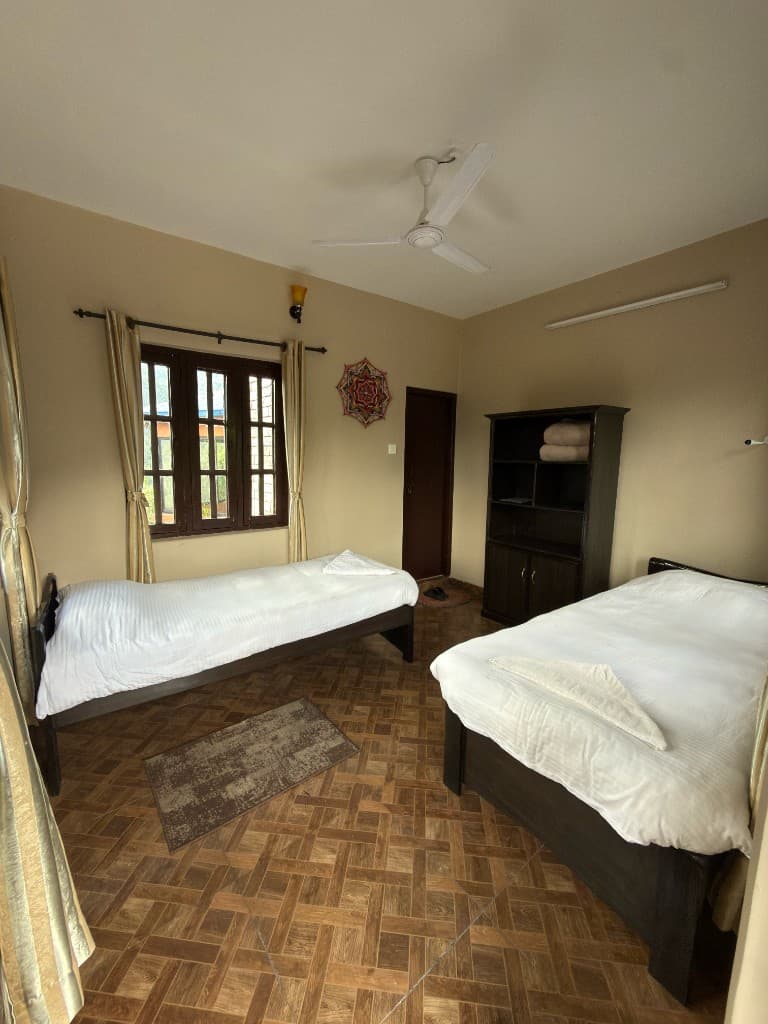 Comfortable twin bedroom with natural light and minimalist decor at Yogaban Retreat
