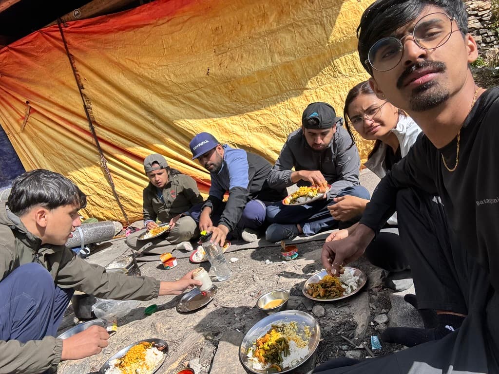 Group cooking and eating lunch at Bisket Mela on the North ABC trek