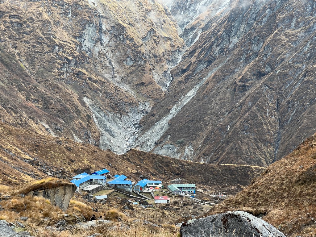 Blue-roofed teahouses in a high mountain valley on the ABC trek