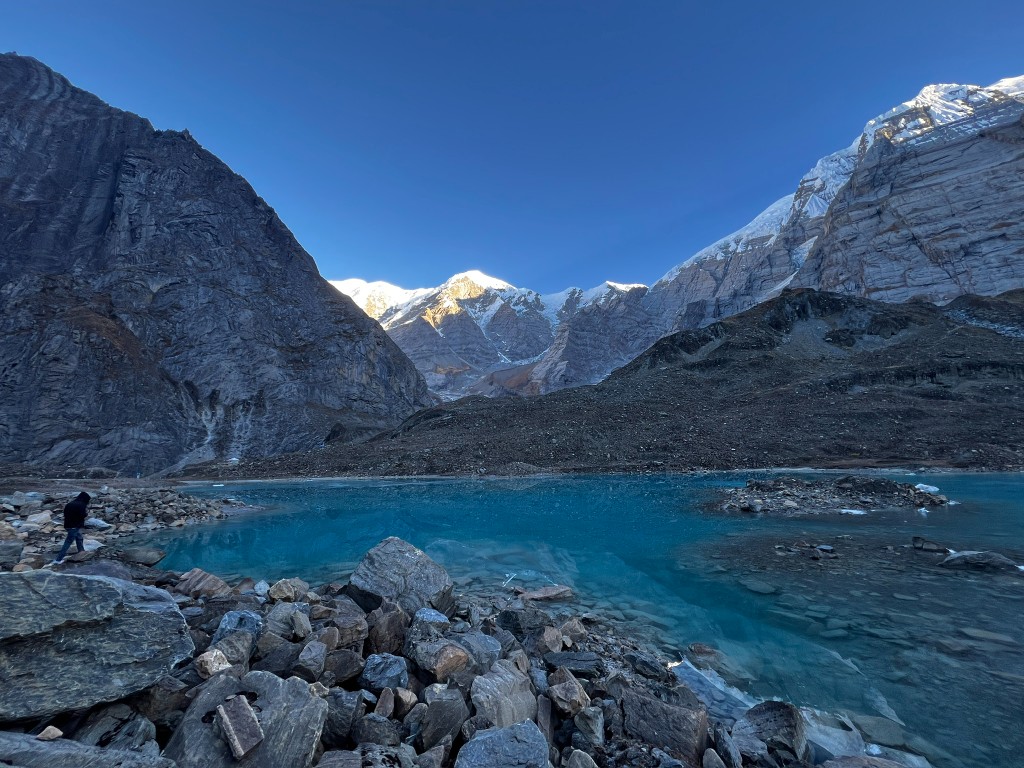 Turquoise glacial Pancha Kunda Lake surrounded by Annapurna mountains