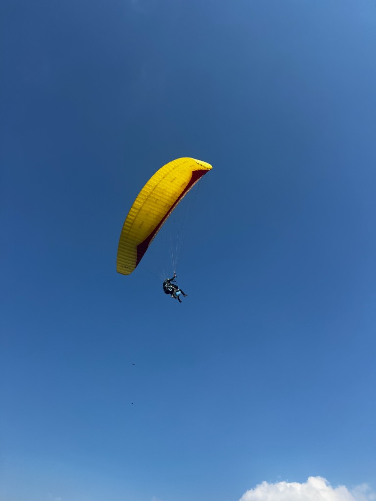 Paraglider soaring through the sky above Pokhara