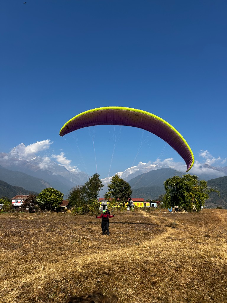 Tandem paragliding launch with Machhapuchhre in the background